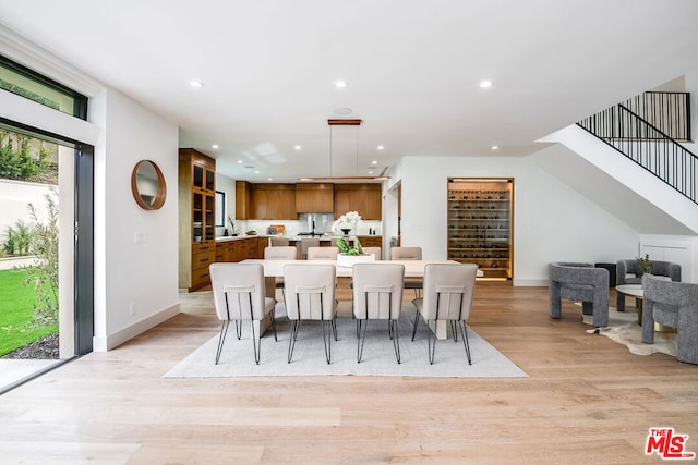 dining area with light wood-type flooring and sink