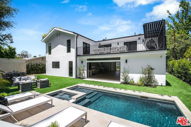 rear view of property featuring a lawn, a pool with hot tub, an outdoor living space, a balcony, and a patio