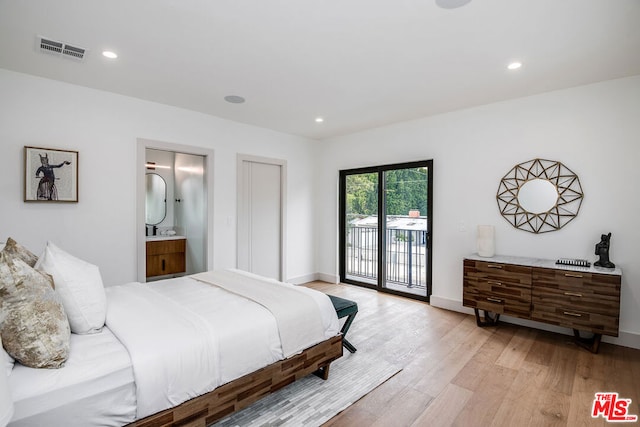 bedroom featuring access to outside, connected bathroom, and light hardwood / wood-style flooring