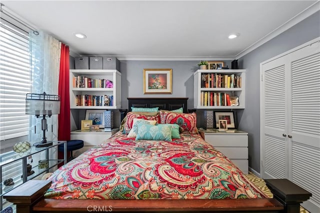 bedroom featuring a closet and crown molding