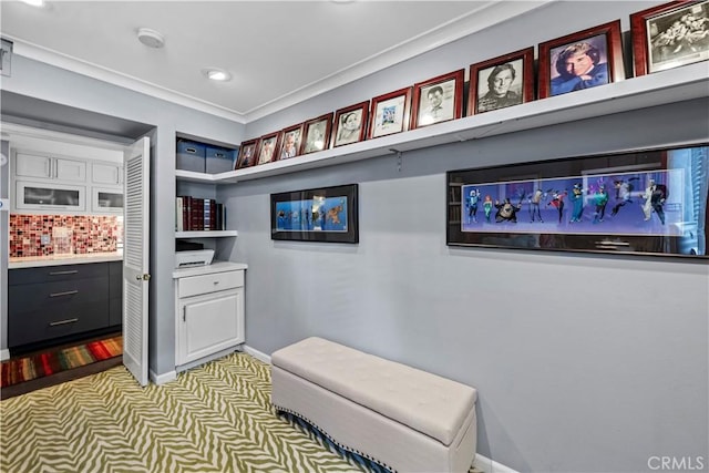 interior space with ornamental molding and light carpet