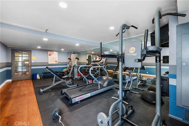 exercise room with hardwood / wood-style floors