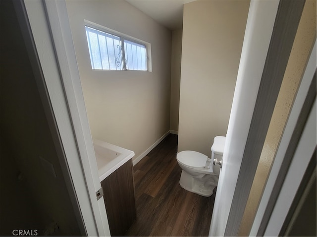 bathroom with hardwood / wood-style floors and toilet