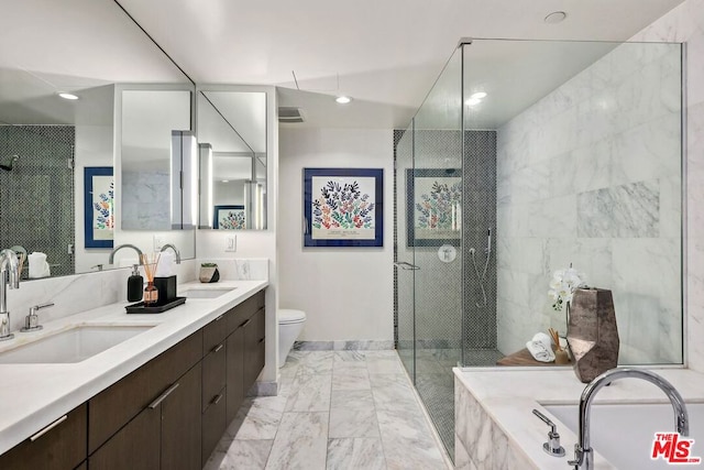 full bathroom featuring independent shower and bath, vanity, and toilet