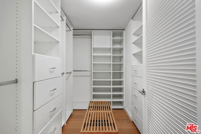 walk in closet featuring hardwood / wood-style flooring