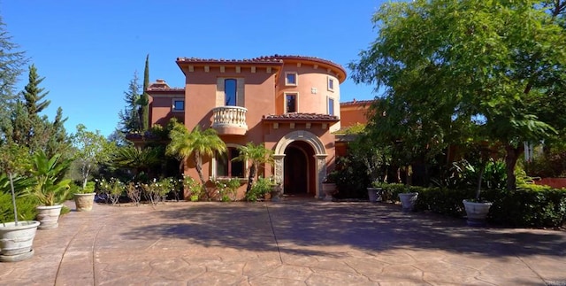 mediterranean / spanish home with a patio and a balcony