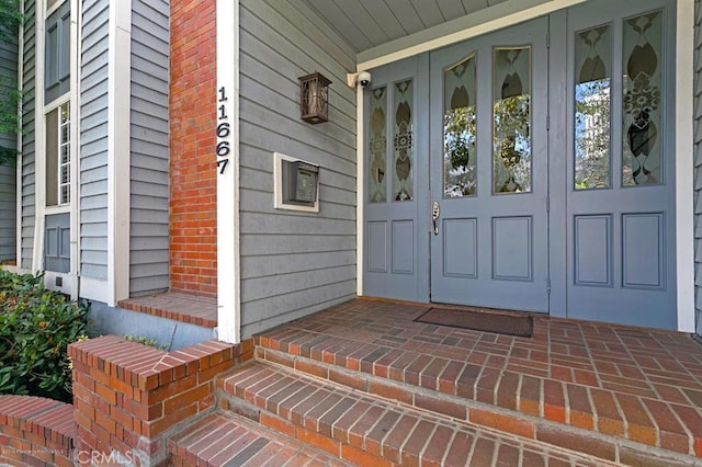 view of exterior entry with covered porch