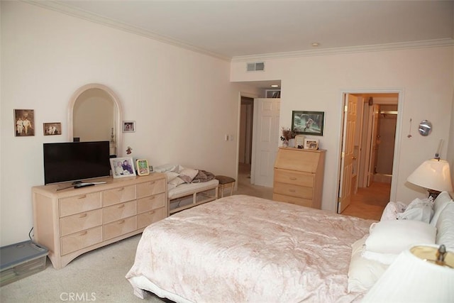 bedroom featuring light colored carpet and crown molding