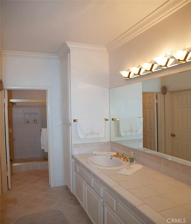 bathroom with vanity, tile patterned flooring, ornamental molding, and a stall shower