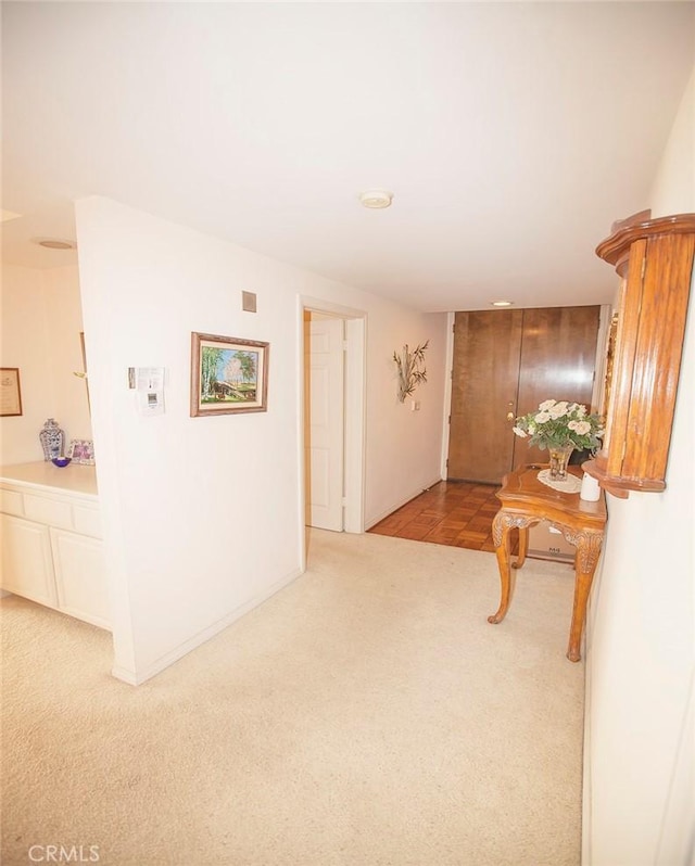 corridor with light colored carpet