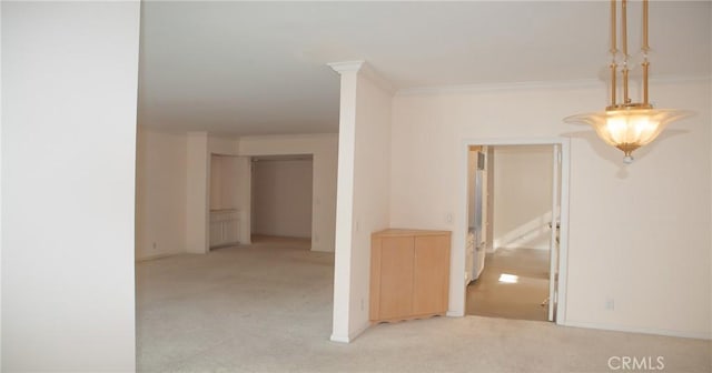 interior space featuring crown molding, baseboards, and light carpet
