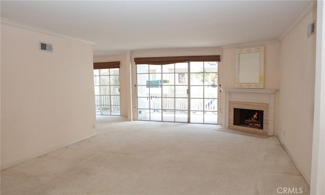 unfurnished living room with visible vents, carpet, and crown molding