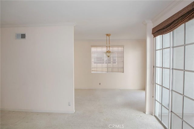 carpeted spare room featuring baseboards, visible vents, ornamental molding, and a healthy amount of sunlight