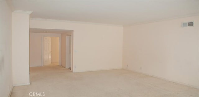 empty room with visible vents, baseboards, crown molding, and light carpet