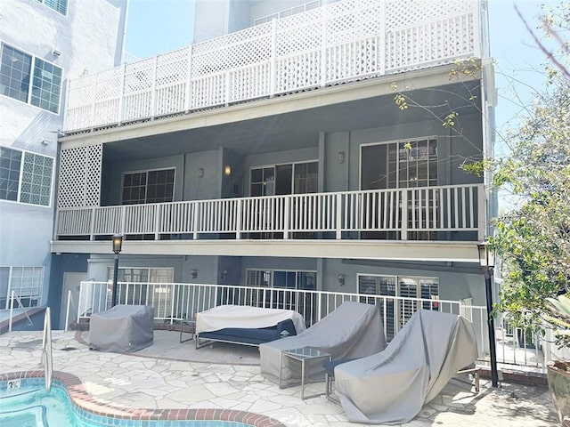 exterior space with a patio, a fenced in pool, and stucco siding