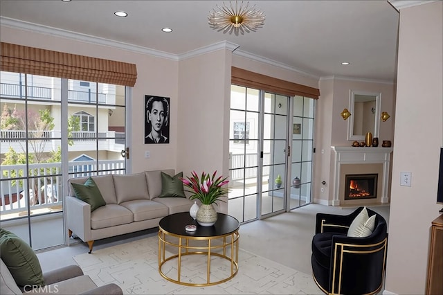 living area with a lit fireplace, ornamental molding, plenty of natural light, and recessed lighting