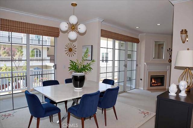 11667 Gorham Ave Unit 306, Los Angeles, CA 90049 - dining room featuring crown molding, a lit fireplace, and recessed lighting