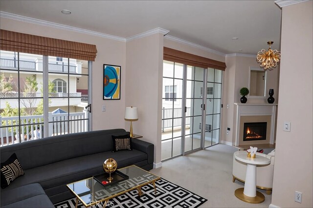 11667 Gorham Ave Unit 306, Los Angeles, CA 90049 - carpeted living area featuring healthy amount of natural light, a chandelier, baseboards, crown molding, and a warm lit fireplace