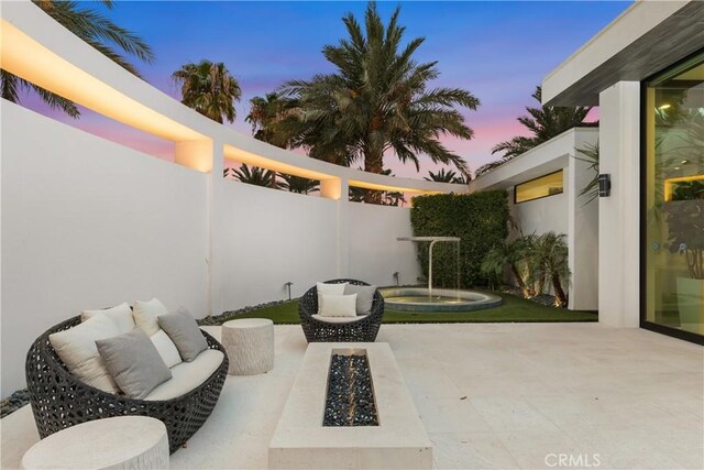 patio terrace at dusk with an outdoor fire pit