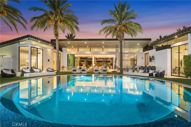 pool at dusk with a patio