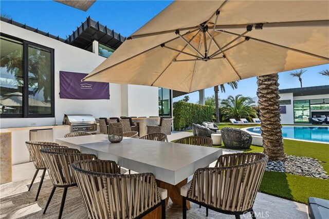 view of patio with exterior bar, an outdoor kitchen, and a grill