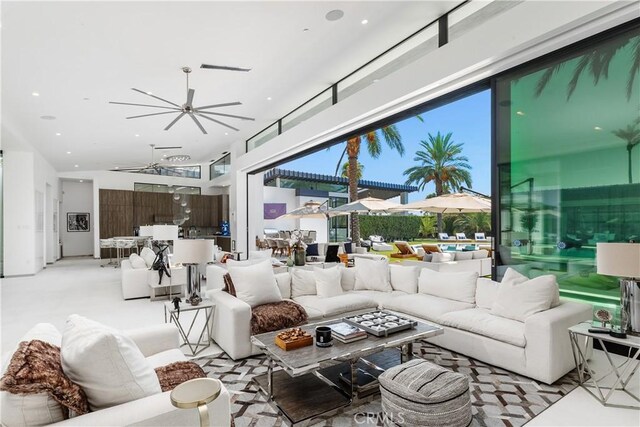 carpeted living room with ceiling fan