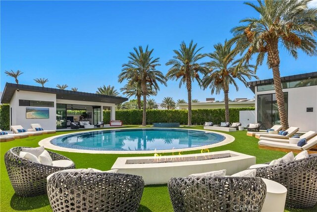 view of swimming pool featuring outdoor lounge area and a yard