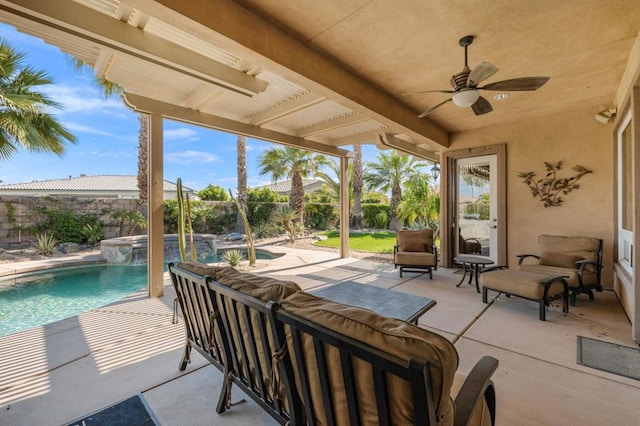 view of patio / terrace with pool water feature, ceiling fan, a swimming pool with hot tub, and outdoor lounge area