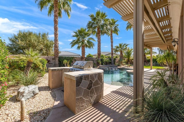 view of pool featuring exterior kitchen, area for grilling, a patio area, and a pergola