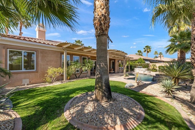 rear view of property with a patio, a lawn, and a pergola