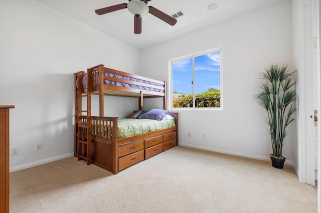 bedroom featuring light carpet and ceiling fan