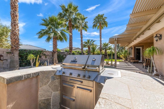 view of patio featuring an outdoor kitchen, area for grilling, and a pergola