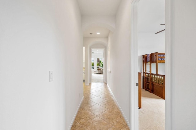 hall featuring light tile patterned floors