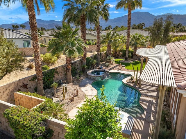 view of swimming pool featuring an in ground hot tub and a mountain view