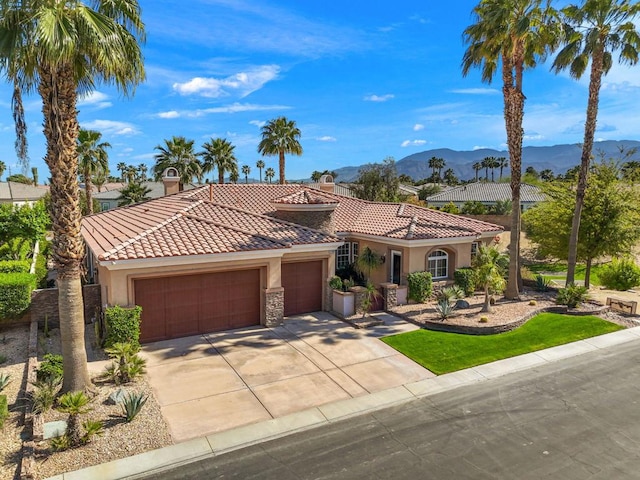 view of front of property featuring a garage and a mountain view