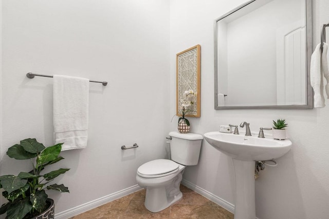 bathroom with sink, tile patterned floors, and toilet