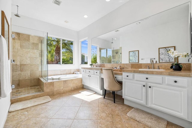 bathroom with tile patterned floors, vanity, and shower with separate bathtub