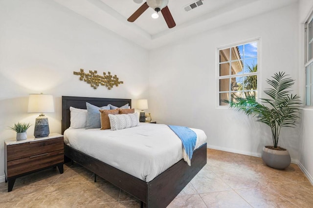 bedroom featuring a raised ceiling and ceiling fan