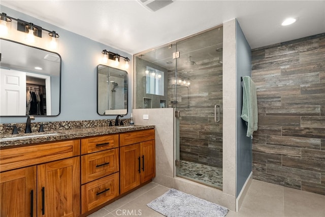 bathroom with tile patterned flooring, vanity, and an enclosed shower