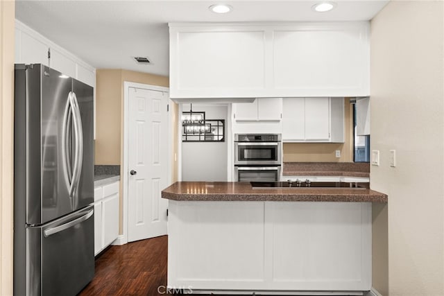 kitchen featuring kitchen peninsula, white cabinetry, dark wood-type flooring, and stainless steel appliances