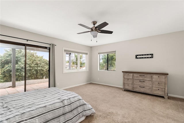 carpeted bedroom featuring ceiling fan and access to exterior