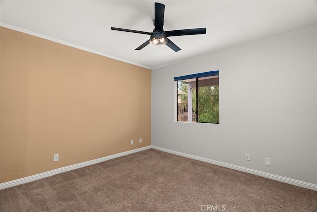 empty room featuring carpet flooring, ceiling fan, and crown molding