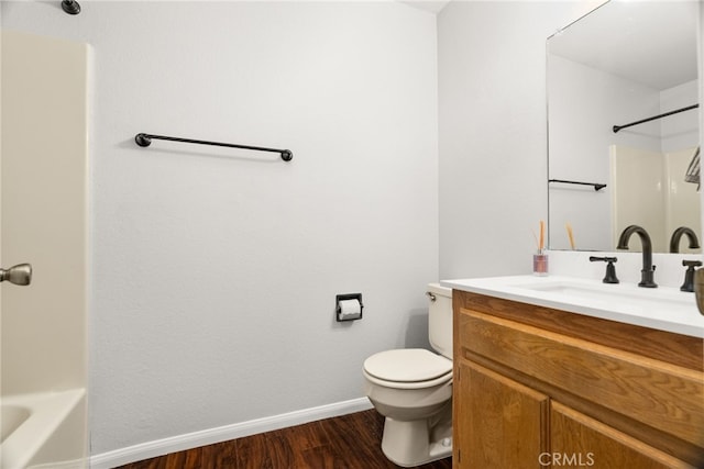 bathroom featuring hardwood / wood-style flooring, vanity, and toilet