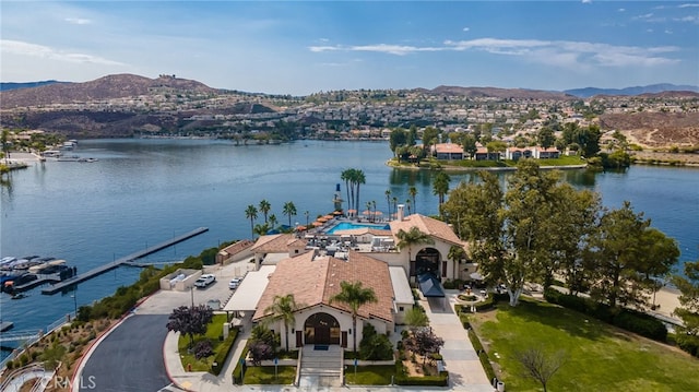 birds eye view of property with a water and mountain view