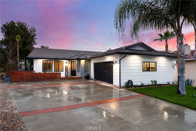 ranch-style home featuring a garage