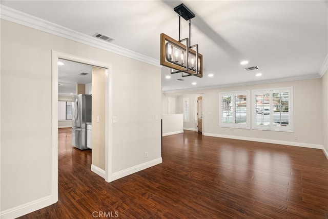 unfurnished living room with crown molding, dark wood-type flooring, and a notable chandelier