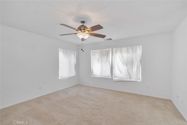 carpeted spare room with ceiling fan