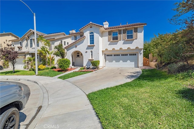 mediterranean / spanish home with a front lawn and a garage