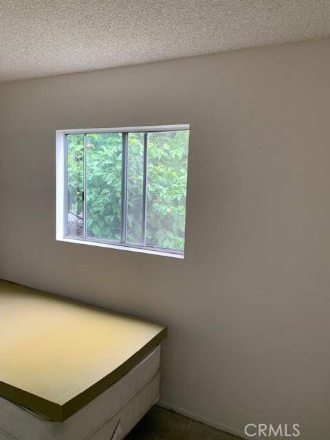 unfurnished bedroom with a textured ceiling