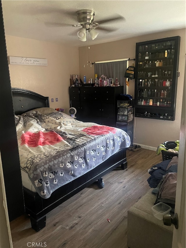 bedroom with ceiling fan and hardwood / wood-style flooring